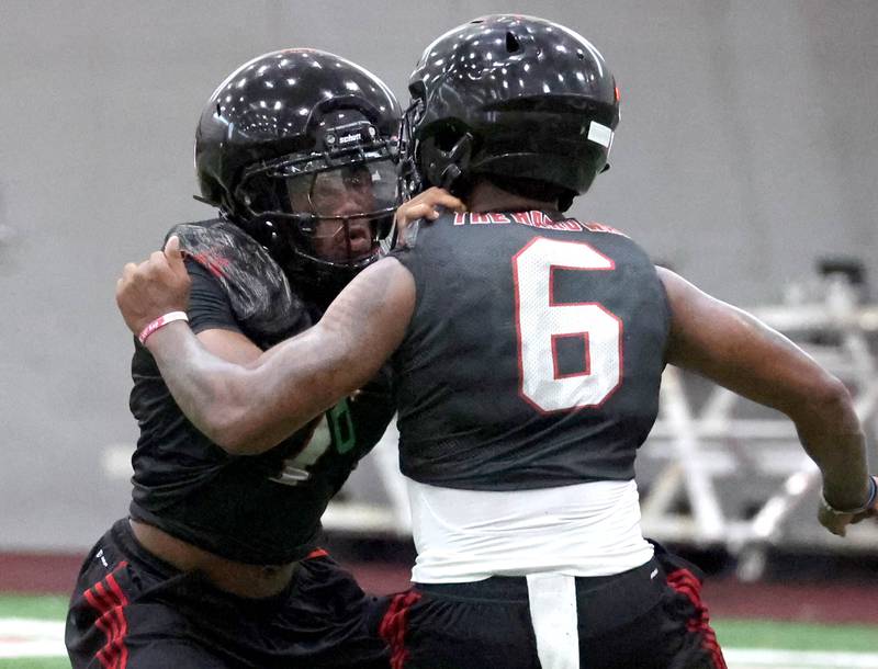 Northern Illinois’ Gary Givens (left) and DeAree Rogers participate in a drill Wednesday, July 30, 2025, at the teams first practice of the season in the Chessick Practice Center at NIU in DeKalb.