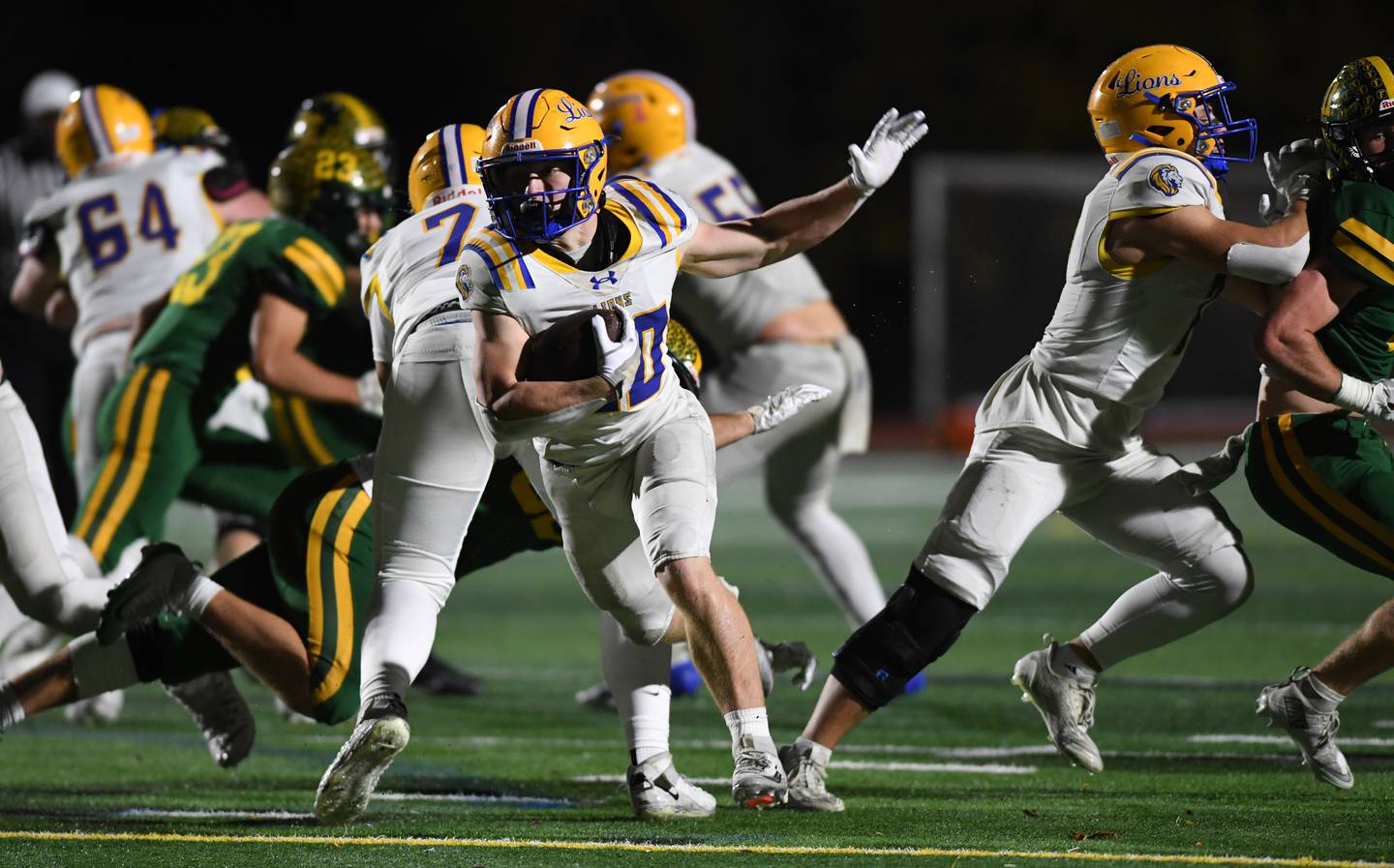 Lyons Township’s EJ Kuhlman carries the ball for a third-quarter touchdown during a second-round Class 8A football playoff game against Fremd in Palatine Friday.