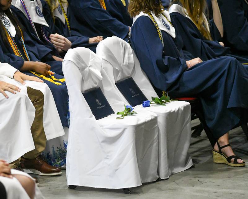 Two chairs were left empty to honor two students during the Oswego East graduation on Saturday May 17, 2025, held at the Convocation Center in DeKalb.