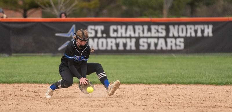 St. Charles North's Margo Geary (13) fields a grounder against St. Charles East during a softball game at St. Charles East High School on Monday, April 25, 2022.
