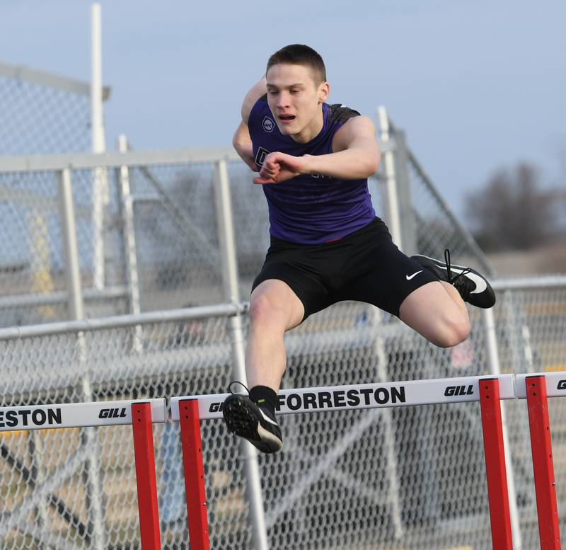 Dixon's Cullen Shaner clears a hurdle as heads to the finish line in the 300 meter hurdles during a Thursday, March 23 meet in Forreston. Shaner won the race.