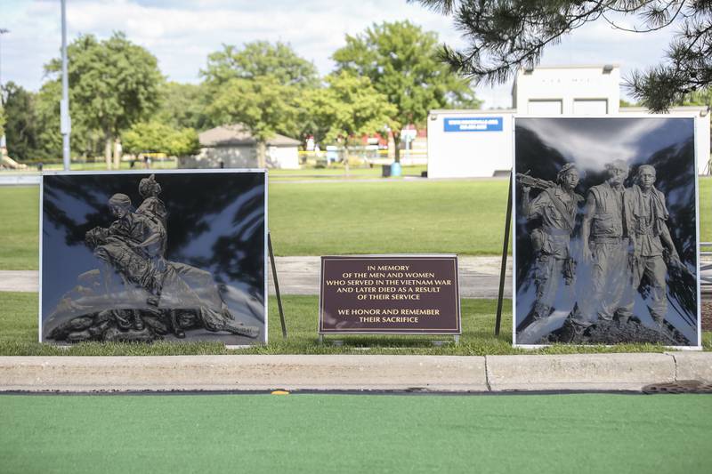 Two pictures honoring the fallen soldiers at the Vietnam Traveling Memorial Wall Thursday, Aug 21, 2025  in Romeoville.