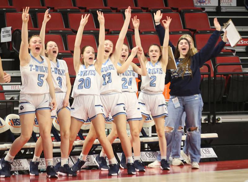 Members of the Cissna Park girls basketball team react after teammate Josie Neukomm hits a three point basket against Cissna Park during the Class 1A third place game on Friday, March 7, 2025 at CEFCU Arena in Normal.