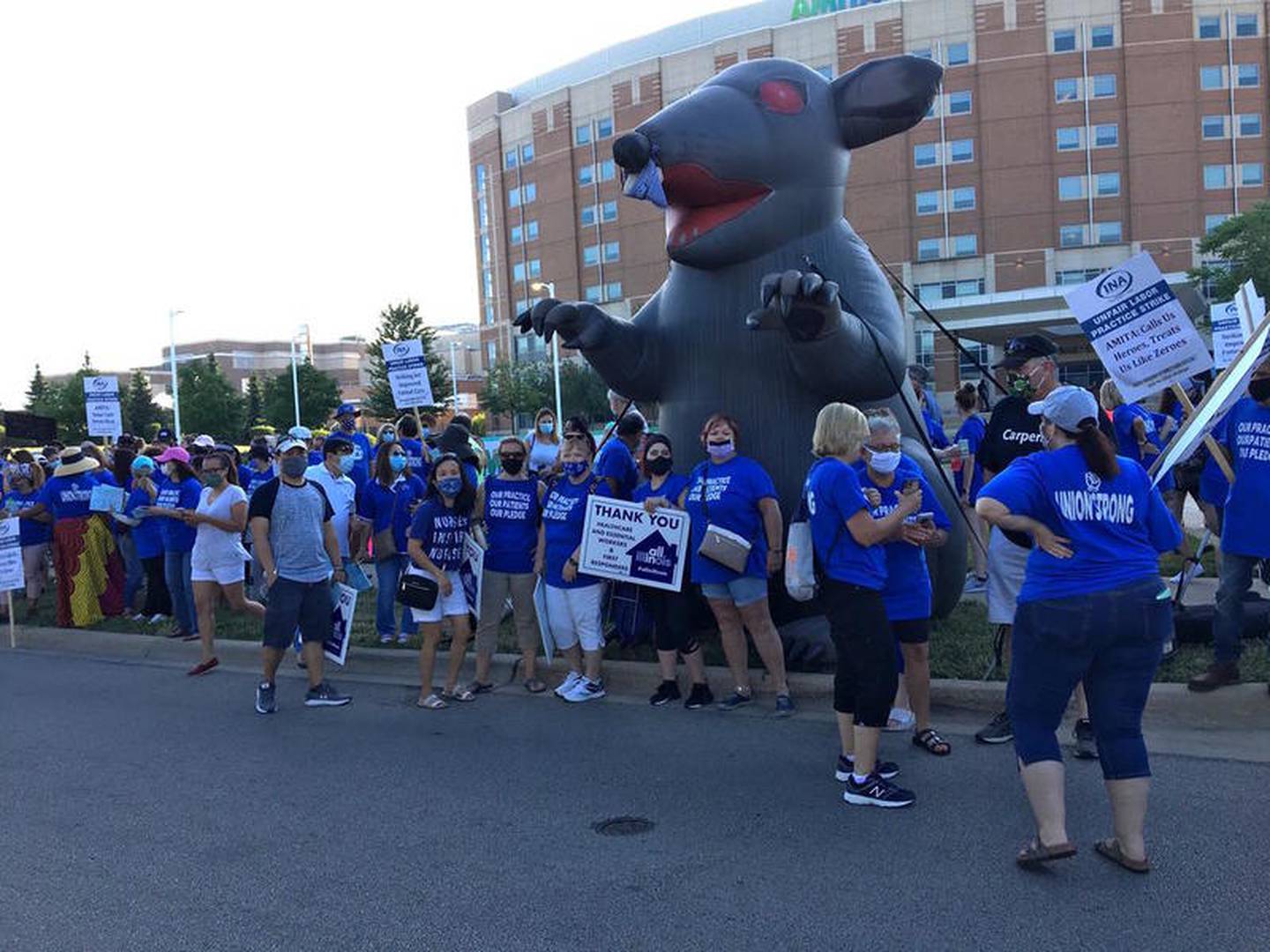 Nurses with Illinois Nurses Association go on strike at AMITA Health Saint Joseph Medical Center with the Scabby the Rat inflatable on Saturday in Joliet.