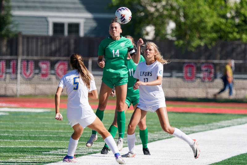 York’s Michaela Quinn (14) goes up for a header against Lyons’ Jillian Herchenroether (5) and Izzi Lebar (17) during a Class 3A Hinsdale Central Sectional girls soccer championship match at Hinsdale Central High School on Saturday, May 25, 2024.