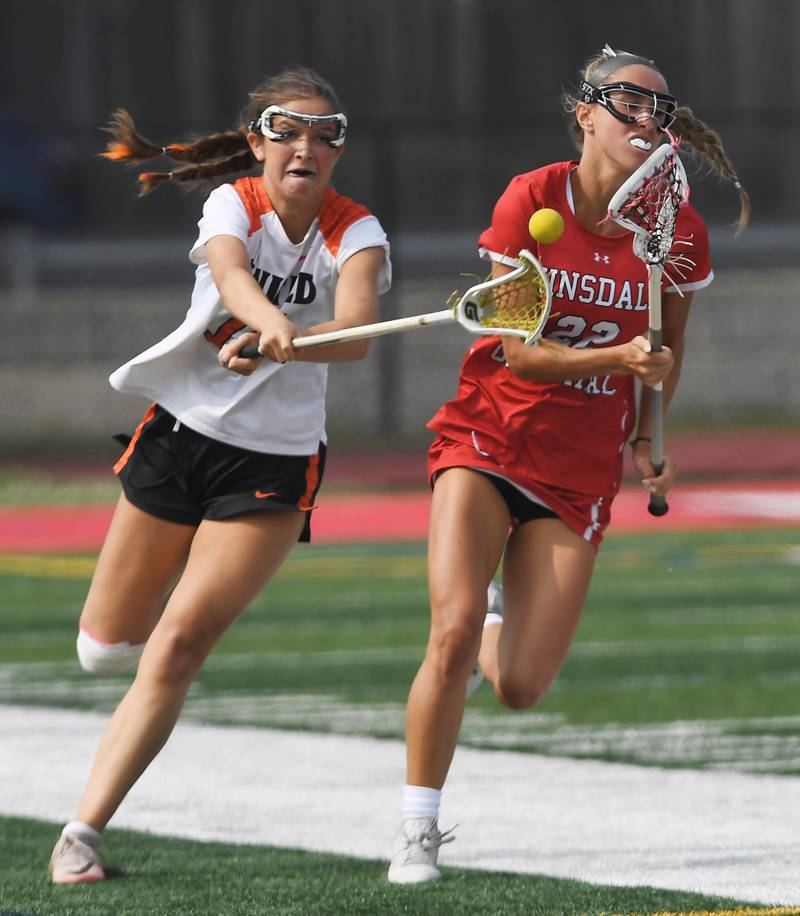 Crystal Lake Central Coop’s Sydney Cruz, left, dislodges the ball from Hinsdale Central’s Gabriella De Vita during the third-place game of the girls lacrosse state finals at Hinsdale Central High School on Saturday, June 7, 2025.