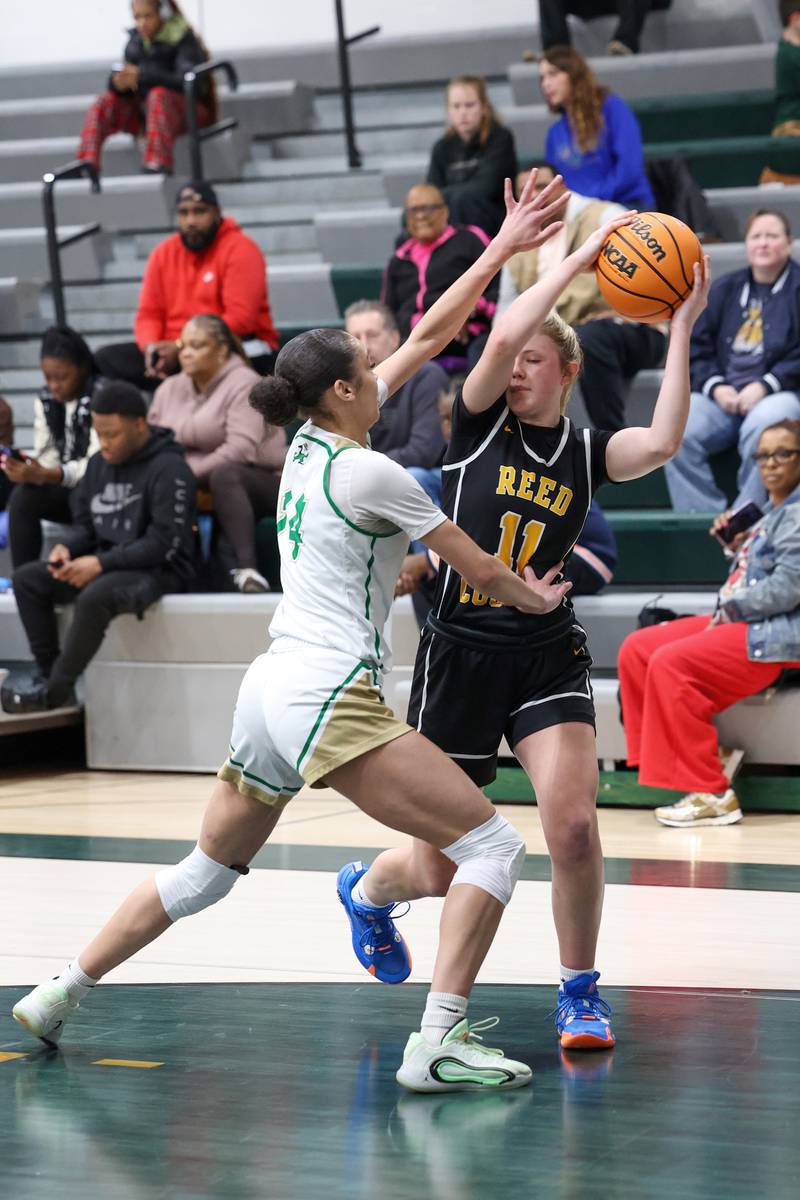 Reed-Custer's Morgan Toler looks to pass around Bishop McNamara's Jaide Burse during Bishop McNamara's 60-36 victory over Reed-Custer in the IHSA Class 2A Bishop McNamara Regional semifinals on Monday, Feb. 16, 2026.