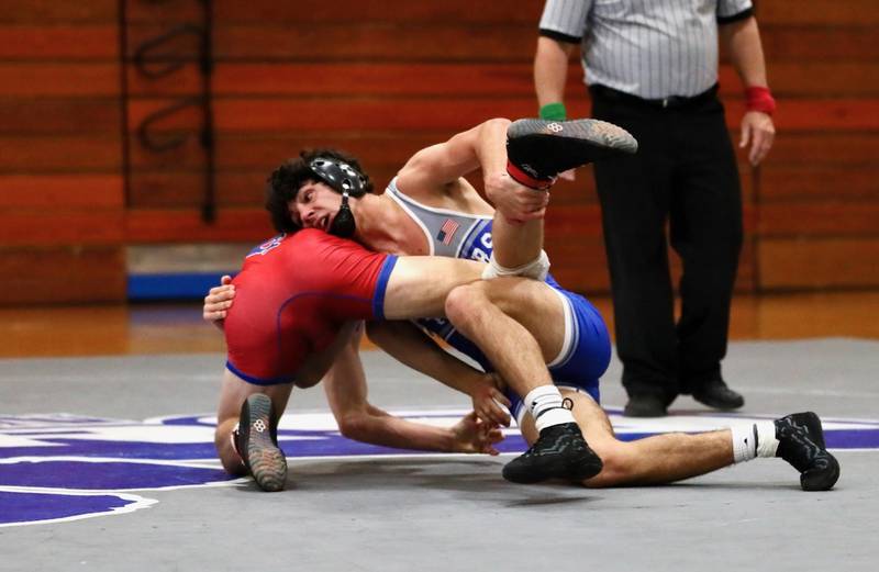 Princeton's Ace Christiansen gets a leg up against Morrison's Pruis Thursday night at Prouty Gym.