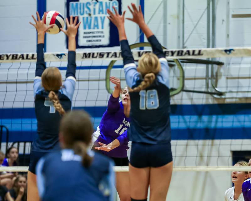 Downers Grove North's Jennifer Buehler (16) smashes the ball past the defense during volleyball match between Downers Grove North at Downers Grove South.  Sept 7, 2023.