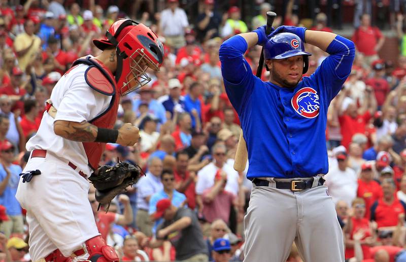 St. Louis Cardinals catcher Yadier Molina, left, pumps his fist as Chicago Cubs' Welington Castillo stands at the plate after Castillo was called out on strikes to end a baseball game Thursday, May 7, 2015, in St. Louis. The Cardinals won 5-1.