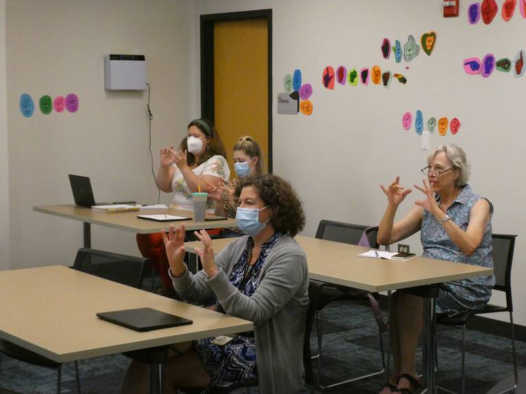 Attendees practice sign language during a deaf sensitivity training at Algonquin Public Library's main branch off Harnish Drive on Tuesday, Aug. 23, 2022.