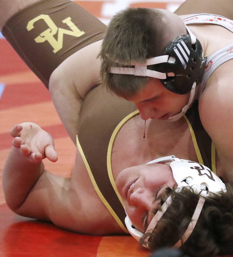 Marian Central's Jimmy Mastny tries to pin Mt. Carmel's Kenneth Segerson in their 190-pound match during a triangle wrestling meet on Saturday Jan. 11, 2025, at between Marian Central, Joliet Catholic, and Mt. Carmel at Marian Central High School in Woodstock.