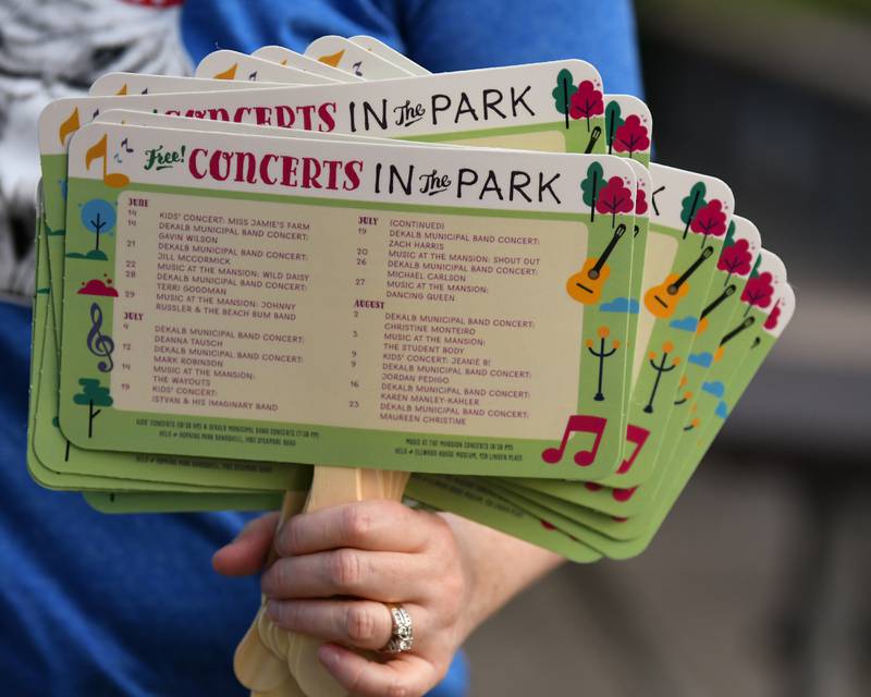 Hand-held fans were passed out to keep attendees cool during the annual DeKalb Municipal Band Independence Day concert at the Dee Palmer Band Shell in Hopkins Park in DeKalb on Monday, July 4, 2022 to celebrate the Fourth of July.