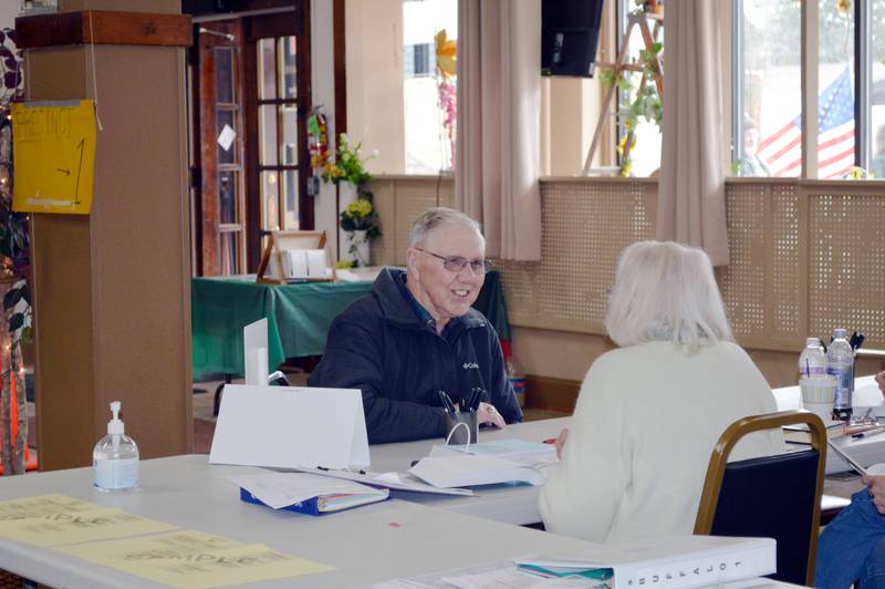 Harold Woodin speaks with an election judge in the Polo Area Senior Center prior to receiving his ballot for the consolidated election on April 4, 2023. About 173 people had voted in the precinct as of 2:35 p.m.