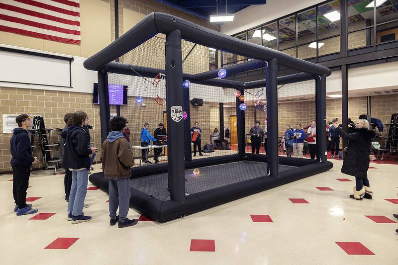 Drone soccer is played inside an inflatable cage. Teams score by flying their striker through the opponents' goal.