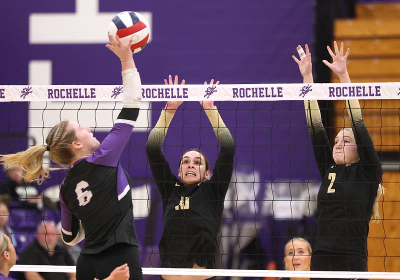 Sycamore's Sophia Lichthardt (left) and Madilyn Patton try to block Dixon's Rayven Mowery Thursday, Oct. 30, 2025, during their Class 3A regional championship match in Rochelle.