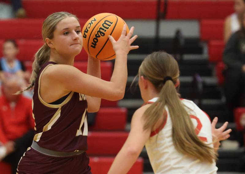 Morris's Alyssa Jepsen looks to pass the ball around Ottawa's Ashlynn Ganiere on Tuesday, Dec. 9, 2025 in Kingman Gymnasium at Ottawa High School.