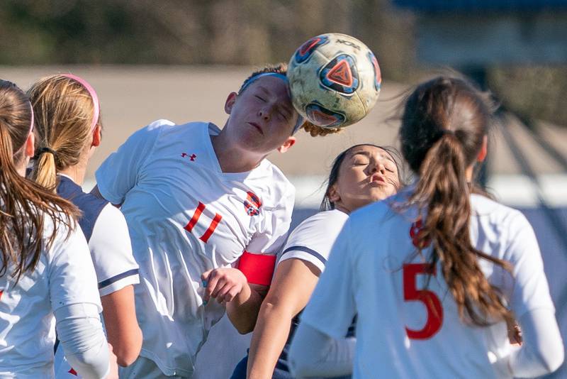 Oswego’s Elaina Hallick (11) goes up for a header against Oswego East during a soccer match at Oswego East High School on Thursday, Apr 6, 2023.