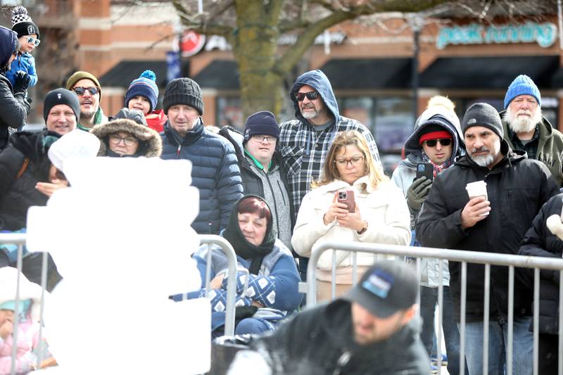 Patrons watch as Jack Neiweem of Nadeau’s Ice Sculptures carves a sea horse out of a block of ice during the Downtown Downers Grove Ice Festival on Saturday, Feb. 1, 2025 in Downers Grove.
