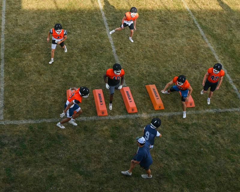 Oswego football team runs some drills before a joint practice with Kaneland High School on Thursday July 10, 2025, held at Oswego High School.