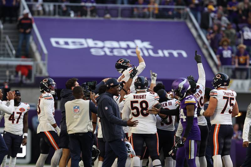 Chicago Bears kicker Cairo Santos (8) is hoisted up by teammates in celebration after kicking the game winning field goal against the Minnesota Vikings during the second half of an NFL football game Sunday, Nov. 16, 2025 in Minneapolis. Chicago won 19-17. (AP Photo/Stacy Bengs)