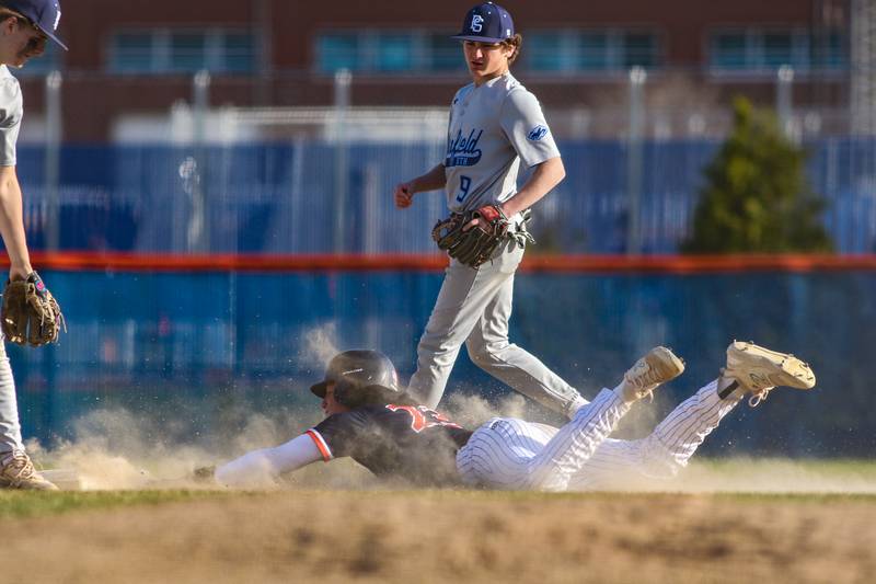 Oswego's Conor Tully (23) slides into second during baseball game between Plainfield South at Oswego on Monday, April 14, 2025 in Oswego.