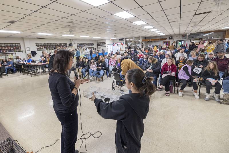 Sharon Peterson (left) and Makayla Stronczek display a box of spiders Saturday, Feb. 7, 2026, at Flock to the Rock.