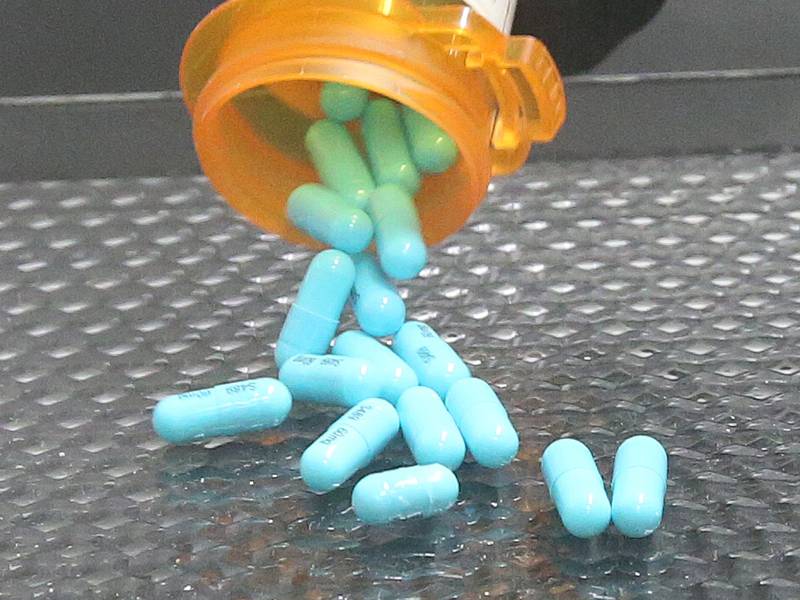 La Salle County Corner Rich Ploch, dumps medication pills onto a hazardous drugs tray inside a filter balancing containment hood at the La Salle County Forensic Center on Wednesday, Aug. 30, 2023 in Oglesby. The hood balances exposures of fumes and other particulates containing powders and removes toxic particulate and other matter when handling the material. State statute requires corners to use machines like this after collecting the medication from the scene of a death.