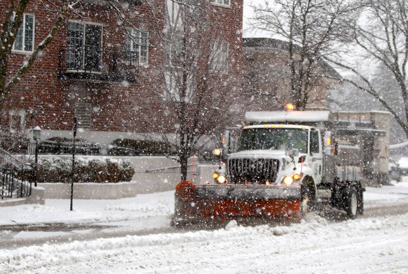 A snow plow clears streets in Glen Ellyn on Tuesday, Jan. 9, 2024.