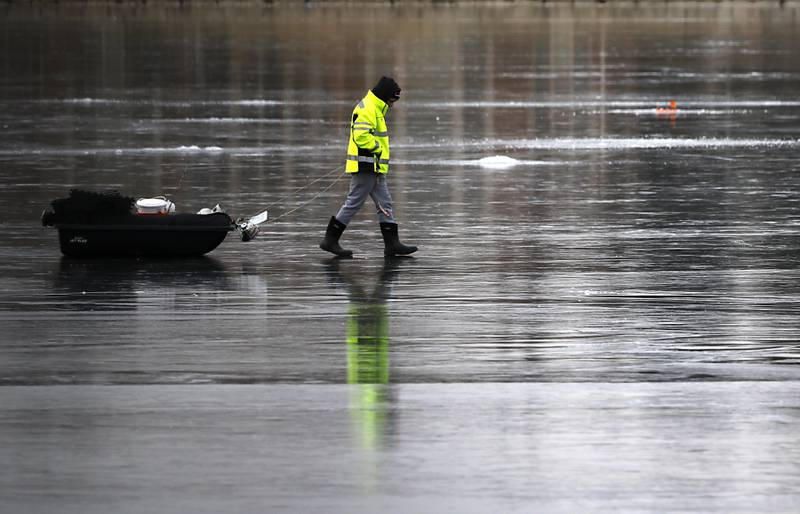 A fisherman pulls his sled of ice fishing gear out to fishing spot on Wednesday, Jan. 8, 2025, on the westside of Crystal Lake near the Lakewood Village Hall.