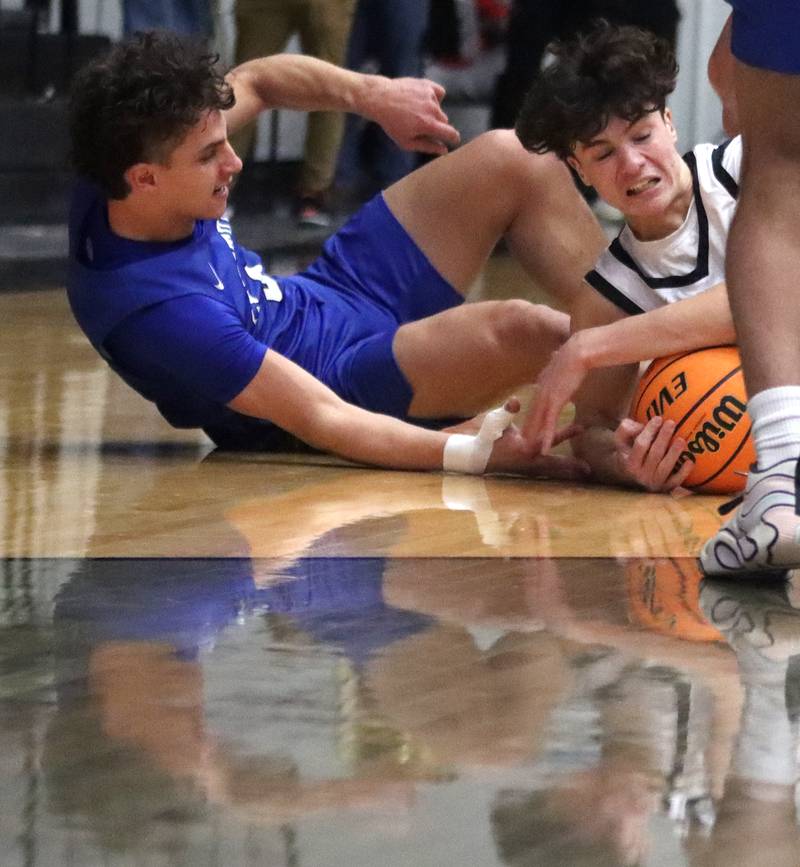 Burlington Central’s  Lucas Kerr, left, battles McHenry’s Marko Stojich in varsity boys basketball on Tuesday, Feb. 4, 2025, at  McHenry High School  in McHenry.