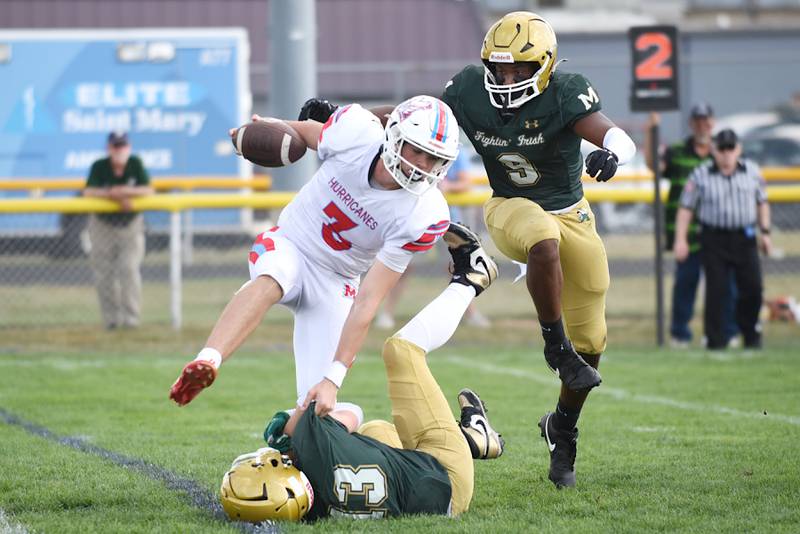 Marian Central's Colin Hernon, left, looks to avoid a tackle from Bishop McNamara's Tucker Inman as the Fightin' Irish's Julius May, right, approaches during a game at Bishop McNamara Saturday, Oct. 4, 2025.