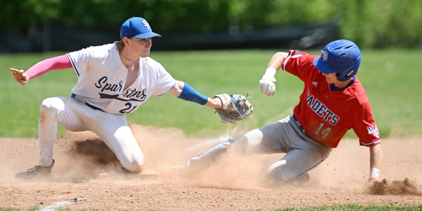 After tagging him on the foot, St. Francis third baseman Nolan Galla pulls his glove away from sliding Marmion base runner Charlie Zebig, who was caught stealing to end the sixth inning of Saturday’s game in Wheaton.