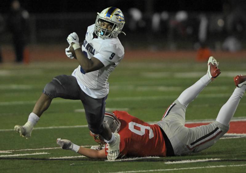 Warren’s Aaron Stewart gets past Palatine’s Jackson Brown in an IHSA Class 8A first round playoff football game in Palatine on Friday, Nov. 1. 2024.