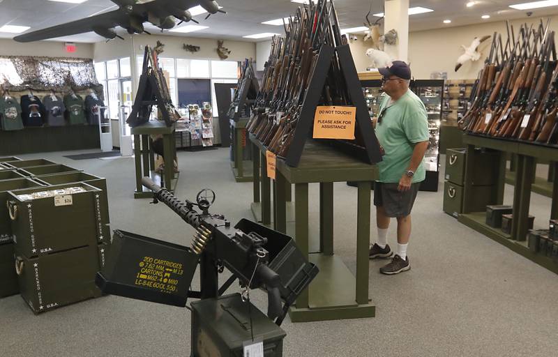 Brad Foote of Marengo looks at guns for sale on Friday, Aug. 11, 2023, at Marengo Guns in Marengo. The Illinois Supreme Court ruled a ban on high-powered rifles and high-capacity magazines did not violate clauses of the Illinois Constitution aimed at ensuring laws are equally applied to all.