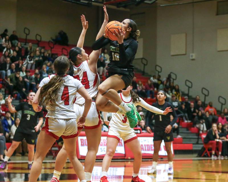 Waubonsie Valley's Danyella Mporokoso (10) hangs in the air on a shot attempt during their Class 4A Bolingbrook Sectional final basketball game between Waubonsie Valley at Benet. Feb 27, 2025 in Bolingbrook.