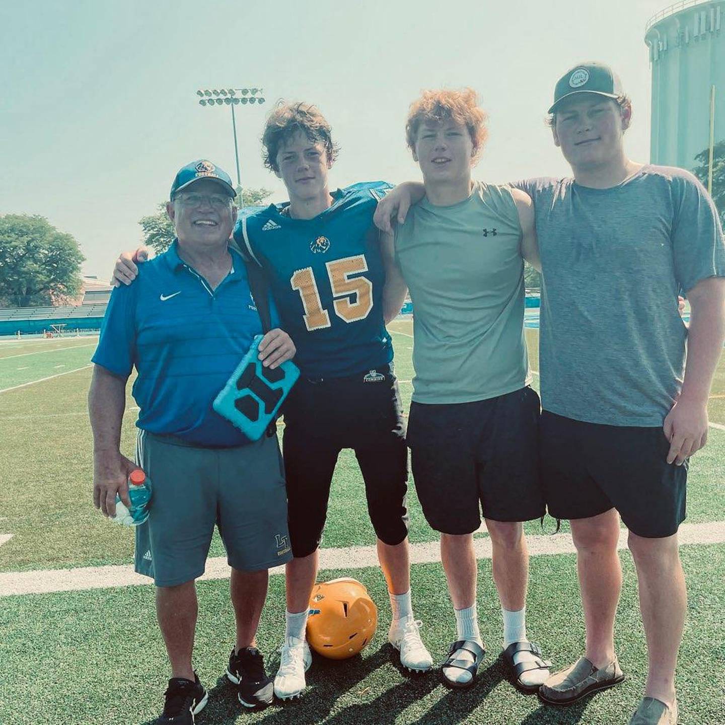 Lyons Township coach Mark King (left) with his grandsons after a football game in the fall of 2021.