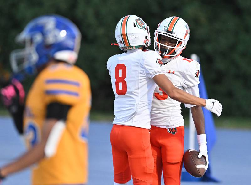 Plainfield East's Markeith Taylor (13) celebrates with Trevor Manuel (8) after scoring a touchdown during the conference game against Joliet Central on Friday, SEP. 12, 2025, at Joliet.