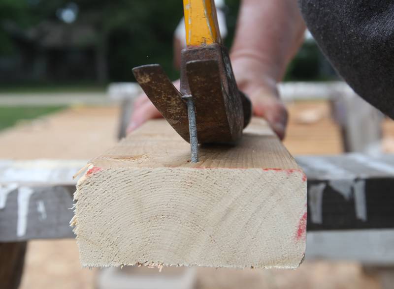A worker removes a nail out of a 2x4 while working on the Habitat for Humanity home on Thursday, July 10, 2025 in Princeton. The home is located near the intersection of Cherry and Marquette Street in Princeton. A family of 6, including 4 young children, will move into the home. Volunteers interested in helping with the home are asked to contact to Habitat for Humanity La Salle, Bureau, Putnam Counties by contacting the Peru office. The home should be completed by the end of the year.