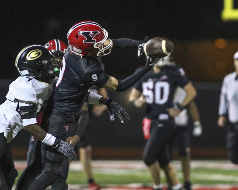 Yorkville's A.J. DiVito (9) has a pass reception broken up by Glenbard North's Jayvion Todd (4) during Class 7A first round football game between Glenbard North at Yorkville. Friday, Oct 31, 2025 in Yorkville.