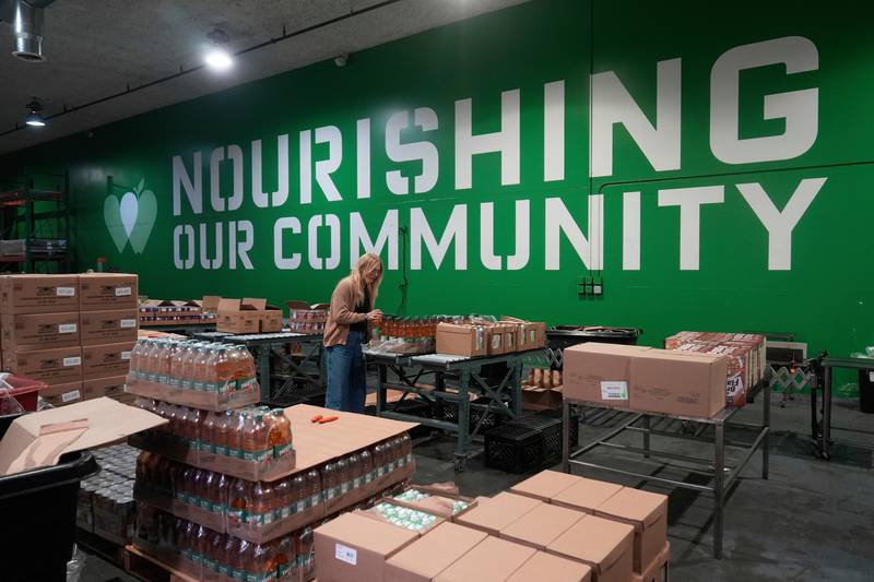 FILE - Mara Sleeter, marketing and communications project manager, stands near boxes of juice while being interviewed in the San Francisco-Marin Food Bank warehouse in San Francisco, July 2, 2025. (AP Photo/Jeff Chiu, File)