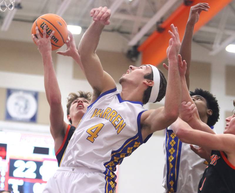 Warren’s Jack Wolf, front, battles McHenry’s Caleb Jett, back fro the ball  in IHSA Class 4A Regional Title Game boys basketball action on Friday, Feb. 28, 2025 at McHenry High School in McHenry.
