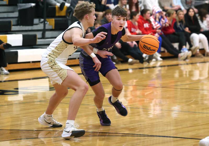 Dixon's Brody Nicklaus works against Sycamore's Isaiah Feuerbach during their game Tuesday, Jan. 14, 2025, at Sycamore High School.