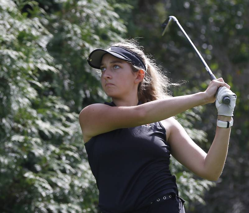 McHenry’s Madison Donovan watches her tee shot on the ninth hole during the Fox Valley Conference Girls Golf Tournament Wednesday, Sept. 21, 2022, at Crystal Woods Golf Club in Woodstock.