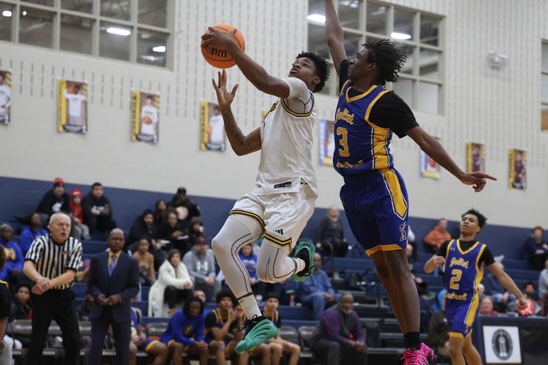 Joliet Catholic’s Jayden Armstrong draws a foul going in for the layup against Joliet Central on Tuesday, Jan 20, 2026 in Joliet.