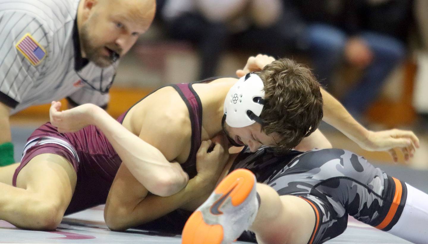 Prairie Ridge’s Tymen Robinson, top, battles McHenry’s Max Ersler at 106 pounds in varsity boys wrestling on Thursday, Jan. 8, 2026 at Prairie Ridge High School in Crystal Lake.