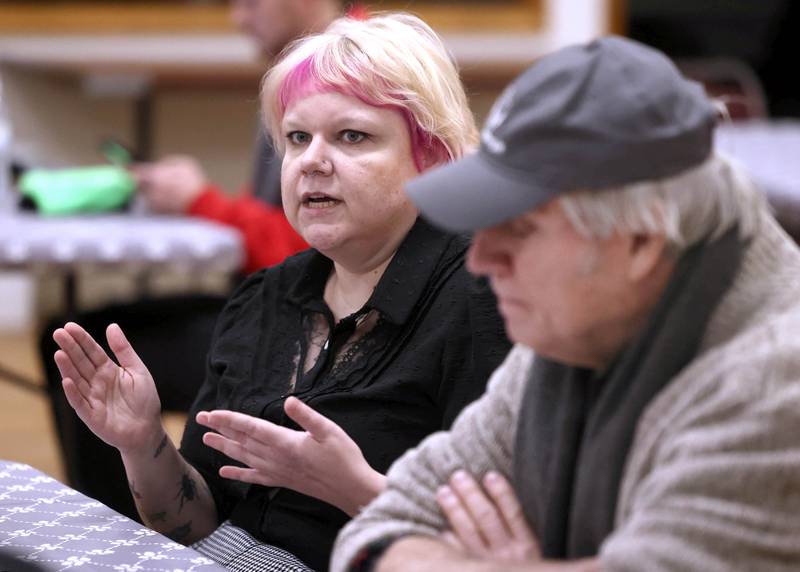 Ash Rootes, director of the overnight warming center at the Unitarian Universalist Fellowship of DeKalb, talks Thursday, Jan. 23, 2025, at the church, about the facility as Dan Kenney, one of the organizers of the center follows along. The warming center, which is open nightly during the winter months, offers free hot meals to all and a warm, safe place for community members.