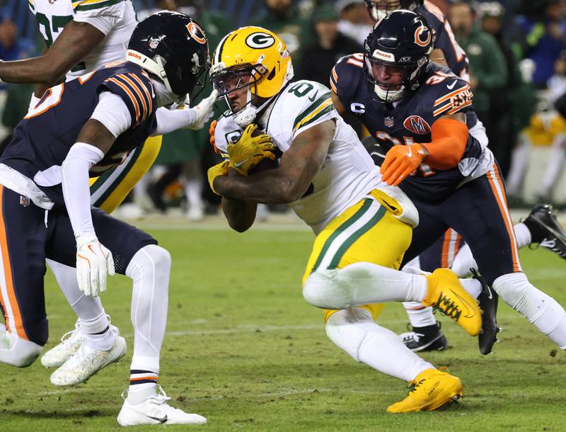 Chicago Bears cornerback Nahshon Wright (left) and safety Kevin Byard III close in on Green Bay Packers running back Josh Jacobs during their NFL Wild Card game Saturday, Jan. 10, 2026, at Soldier Field in Chicago.