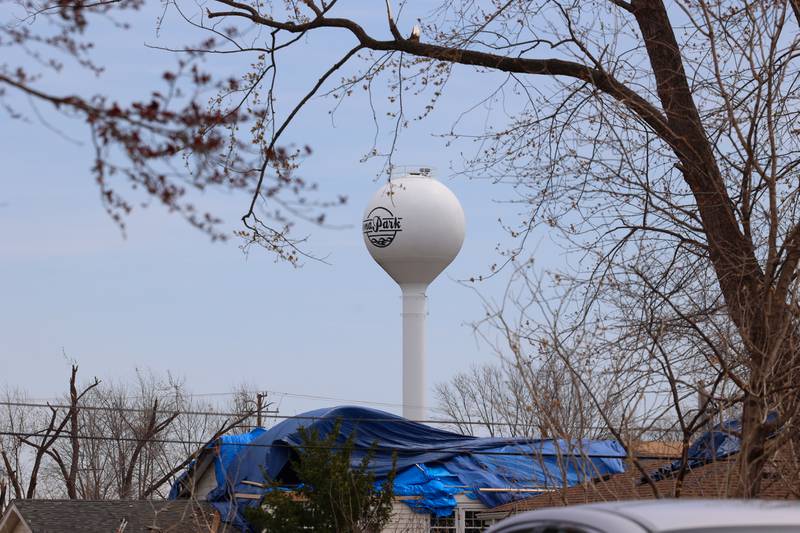 A tarp-covered roof is seen under the Aroma Park water tower on April 8, 2026, nearly one month after the EF-3 tornado.