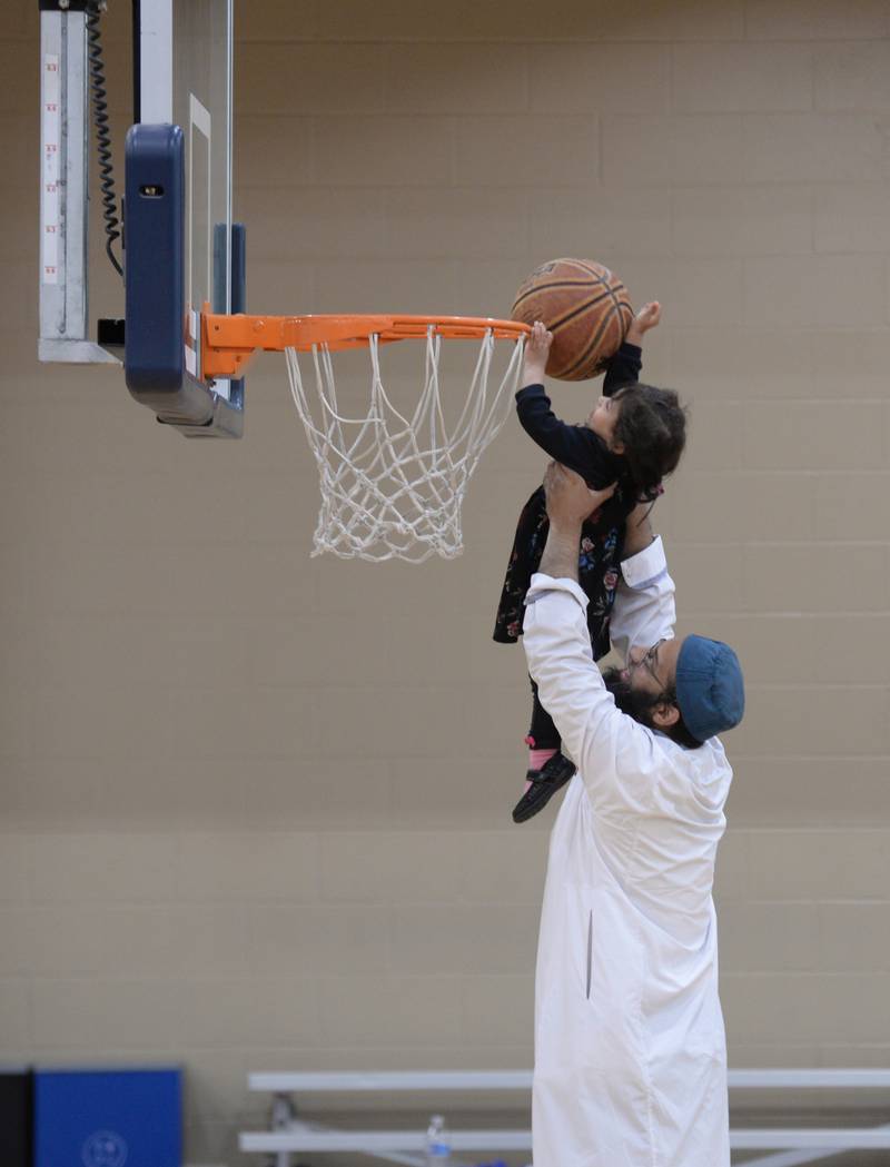 Usman Chaudhry of Glen Ellyn helps his daughter Maryam make a basket while they participate in the Glen Ellyn Park District unplug from technology event held Saturday July 13, 2024.
